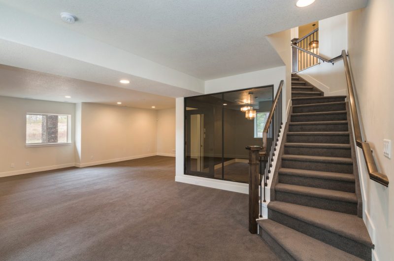 Carpeted stairs to the empty basement room, a separate function room with semi-tinted glass